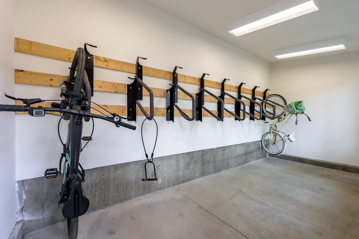 A clean and organized indoor bike storage area with bicycles neatly mounted on the wall, promoting easy access for outdoor adventures.